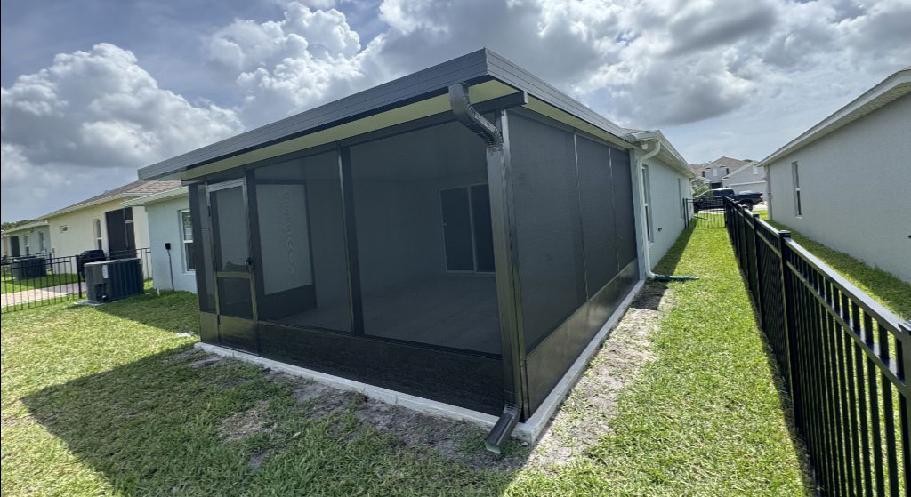 Residential patio screen enclosure installed on a home in Melbourne Florida providing shade, pest protection, and improved outdoor living space.